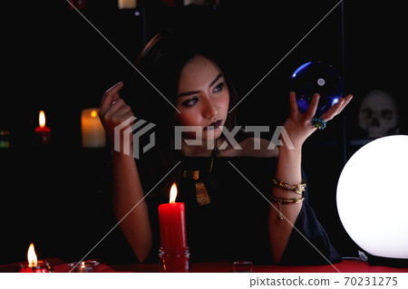 Fortune teller forecast future event or destiny by using crystal ball. 70231275