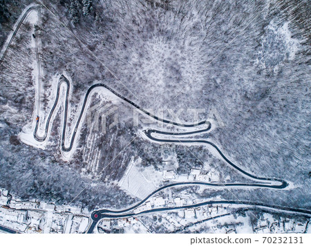 Seasons Concept winter snowy Aerial view Winding road serpentine mountain pass village Brodenbach Germany Seasons Concept winter snowy Aerial view Winding road serpentine mountain pass village Brodenbach Germany 70232131