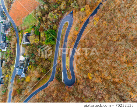 Seasons Concept winter or fall Aerial view Winding road serpentine mountain pass village Brodenbach Germany Seasons Concept winter or fall Aerial view Winding road serpentine mountain pass village Brodenbach Germany 70232133