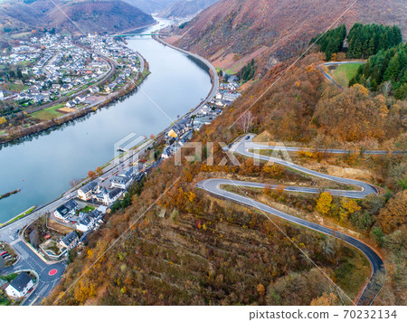 Seasons Concept winter or fall Aerial view Winding road serpentine mountain pass village Brodenbach Germany Seasons Concept winter or fall Aerial view Winding road serpentine mountain pass village Brodenbach Germany 70232134