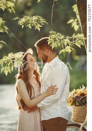 Couple with vintage bicycle in the summer park 70233077