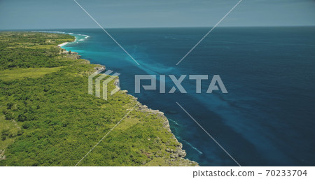 Aerial view of blue ocean bay at green tropic landscape. Greenery grass valley at cliff sea shore 70233704