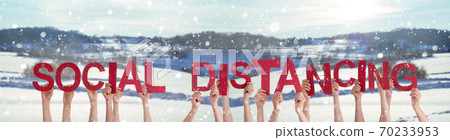 People Hands Holding Word Social Distancing, Snowy Winter Background People Hands Holding Word Social Distancing, Snowy Winter Background 70233953