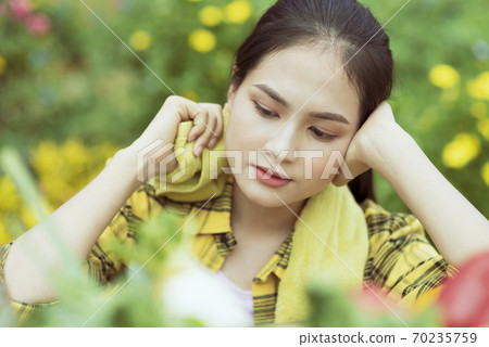 Beautiful female farmer resting Beautiful female farmer resting 70235759