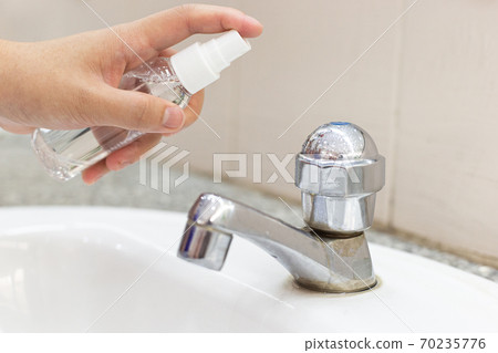 Women's hands are injecting 70% alcohol killing bacteria and the coronal virus or covid-19 to prevent germs, Inhibition of Covid-19 Virus Infection concept. Women's hands are injecting 70% alcohol killing bacteria and the coronal virus or covid-19 to prevent germs, Inhibition of Covid-19 Virus Infection concept. 70235776