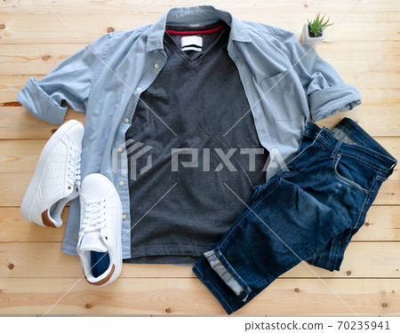 Mockup of blank gray t shirt and jean, white sneakers and denim pants on wooden background. Shirt design for man close up. Flat lay, top view. Mockup of blank gray t shirt and jean, white sneakers and denim pants on wooden background. Shirt design for man close up. Flat lay, top view. 70235941