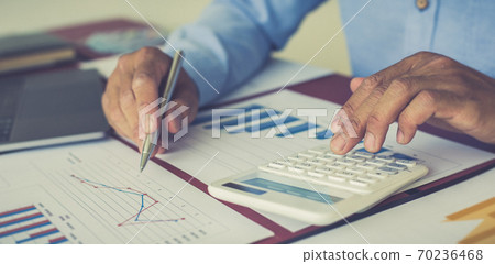 Businessmen analyze market data and calculate the cost of buying-selling products for a client's company, Professional marketing and financial accountants concept. 70236468