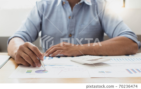 Businessmen analyze market data and calculate the cost of buying-selling products for a client's company, Professional marketing and financial accountants concept. 70236474