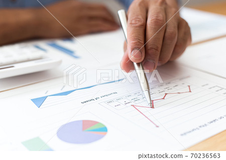 Businessmen analyze market data and calculate the cost of buying-selling products for a client's company, Professional marketing and financial accountants concept. Businessmen analyze market data and calculate the cost of buying-selling products for a client's company, Professional marketing and financial accountants concept. 70236563