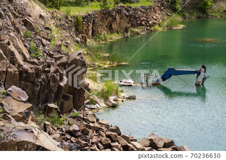 Drowned in flooded basalt quarry excavator Drowned in flooded basalt quarry excavator 70236630