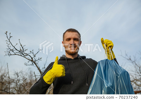 The man in park collect plastic bottles The man in park collect plastic bottles 70237240
