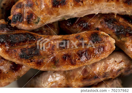 Grilling sausages on barbecue Grilling sausages on barbecue 70237982