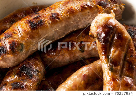 Grilling sausages on barbecue grill view 70237984
