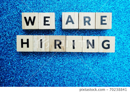 We are Hiring word alphabet letters on blue glitter background 70238841
