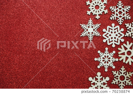 wooden snowflake border frame on red glitter background wooden snowflake border frame on red glitter background 70238874