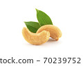 Roasted cashew nuts with green leaves isolated on white. 70239752