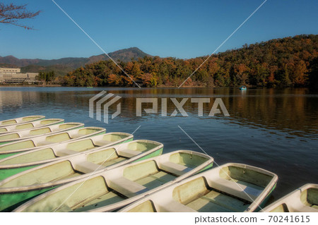 Autumn scenery with a boat floating in Takaragaike and Mt. Hiei in Kyoto 70241615