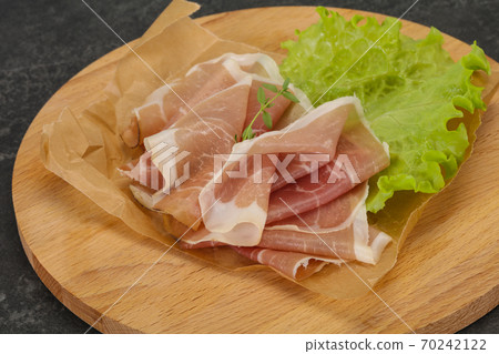 Italian prosciutto pork meat over board 70242122