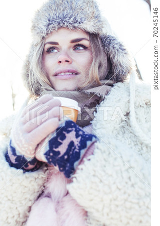 young pretty teenage hipster girl outdoor in winter snow park having fun drinking coffee, warming up happy smiling, lifestyle people concept young pretty teenage hipster girl outdoor in winter snow park having fun drinking coffee, warming up happy smiling, lifestyle people concept 70245146