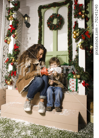 happy smiling family on Christmas at house with gifts, young mother and little son in Santas red hat, lifestyle holiday people concept happy smiling family on Christmas at house with gifts, young mother and little son in Santas red hat, lifestyle holiday people concept 70245240