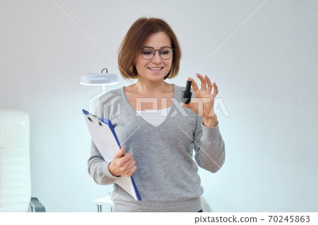 Beauty business, woman owner with clipboard and nail gel polish Beauty business, woman owner with clipboard and nail gel polish 70245863