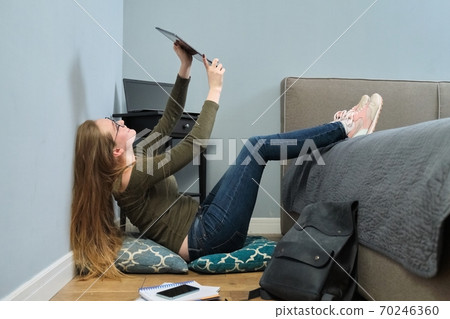 Young woman university student reading digital tablet PC, online education Young woman university student reading digital tablet PC, online education 70246360