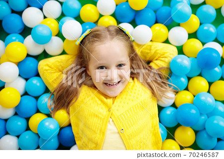 Kids play in ball pit. Child playing in balls pool Kids play in ball pit. Child playing in balls pool 70246587