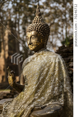 Ancient Stone Sitting Buddha With One Palm Raised 70246712