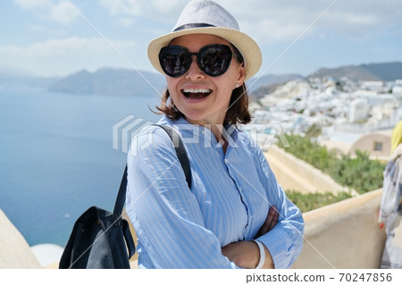 Happy smiling woman tourist traveling on luxury cruise, Greece, Santorini Happy smiling woman tourist traveling on luxury cruise, Greece, Santorini 70247856