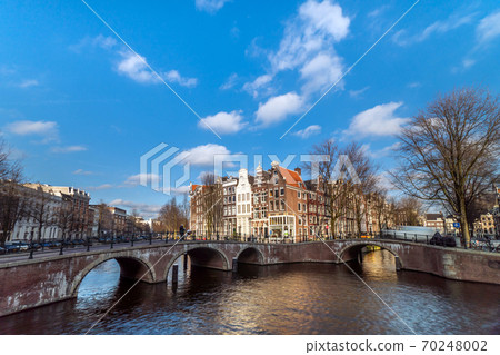 Amsterdam canal in sunny day, Amsterdam is the capital and most populous city in Netherlands. 70248002
