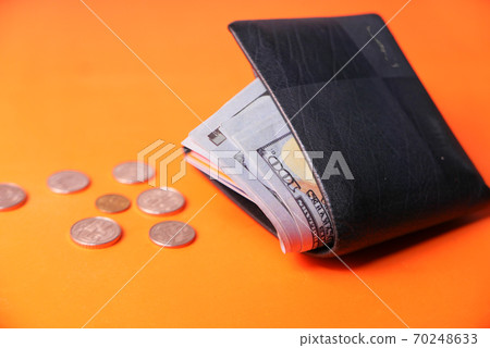 close up o 100 dollar cash in wallet on orange background  70248633