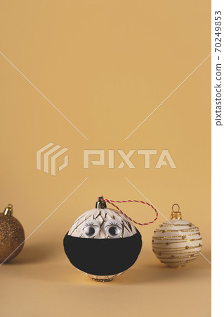 Christmas tree ball in a protective mask from the virus 70249853
