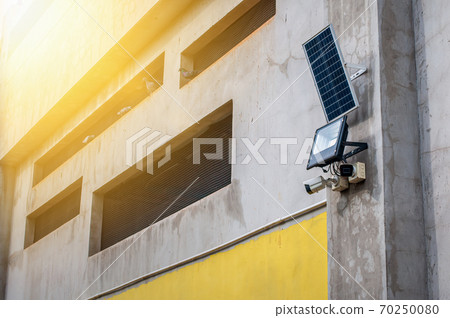 CCTV Camera with LED spot light and solar panel on wall CCTV Camera with LED spot light and solar panel on wall 70250080