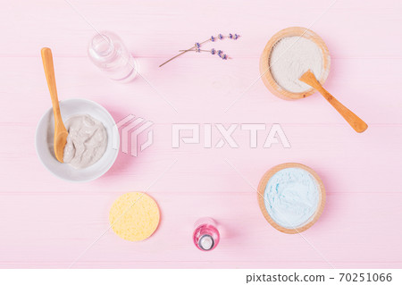 Flat lay cosmetic clay face mask with lavender aroma oil and water on pink background Flat lay cosmetic clay face mask with lavender aroma oil and water on pink background 70251066