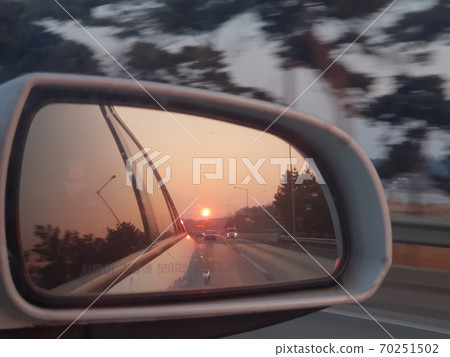 Drive at sunset on a winter day 70251502