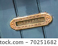 Vintage mailbox inlaid in a blue wooden door 70251682