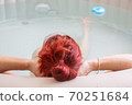 Pretty natural redheaded woman relaxing in her jacuzzi 70251684