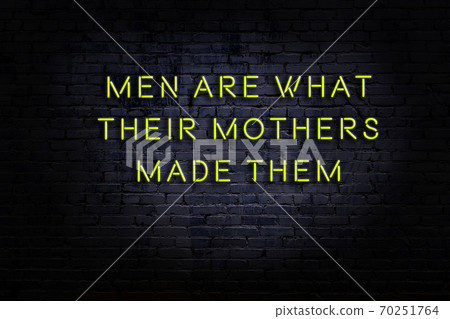 Wise quote. Neon inscription against brick wall Wise quote. Neon inscription against brick wall 70251764