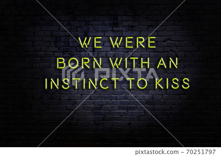 Wise quote. Neon inscription against brick wall Wise quote. Neon inscription against brick wall 70251797