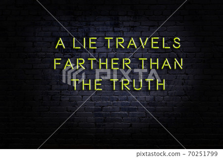 Wise quote. Neon inscription against brick wall Wise quote. Neon inscription against brick wall 70251799