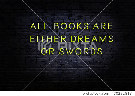 Wise quote. Neon inscription against brick wall 70251818