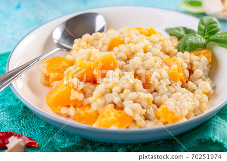 Homemade risotto with pumpkin and parmesan. 70251974