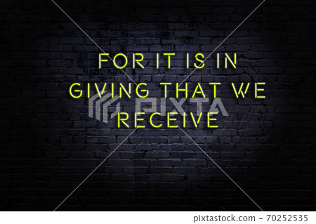 Wise quote. Neon inscription against brick wall Wise quote. Neon inscription against brick wall 70252535