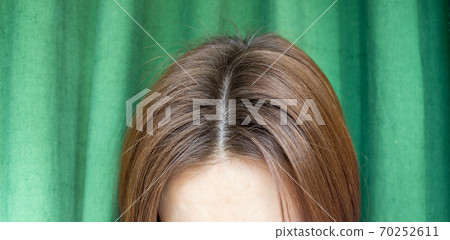 Women's hair after washing on a green background.the view from the top Women's hair after washing on a green background.the view from the top 70252611