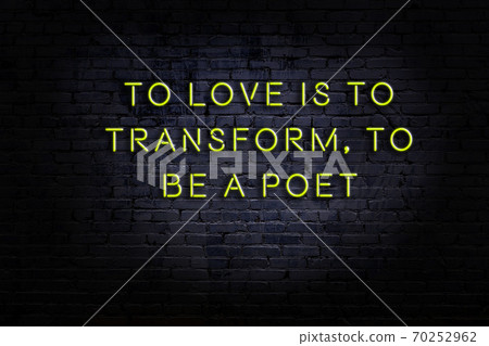 Wise quote. Neon inscription against brick wall Wise quote. Neon inscription against brick wall 70252962