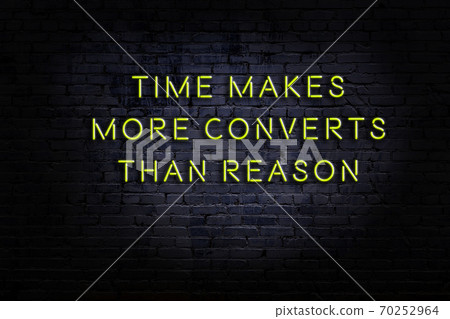 Wise quote. Neon inscription against brick wall 70252964