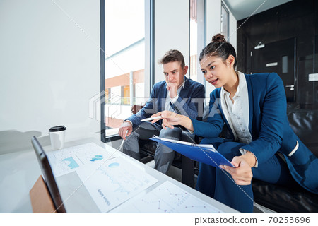 Financial analysts examining data Financial analysts examining data 70253696