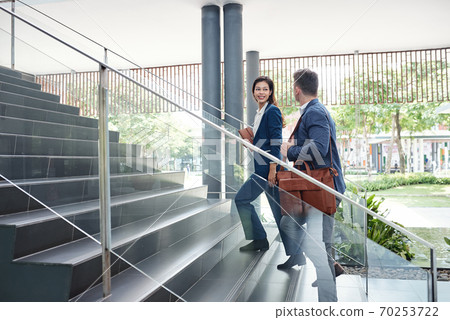 Colleagues walking up the stairs 70253722