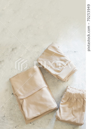 Baby's clothes and on white background top view Baby's clothes and on white background top view 70253949