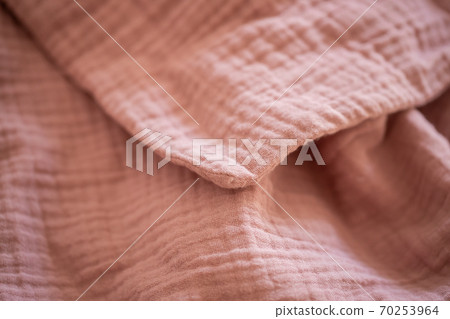 Pink blanket on the bed close up Pink blanket on the bed close up 70253964